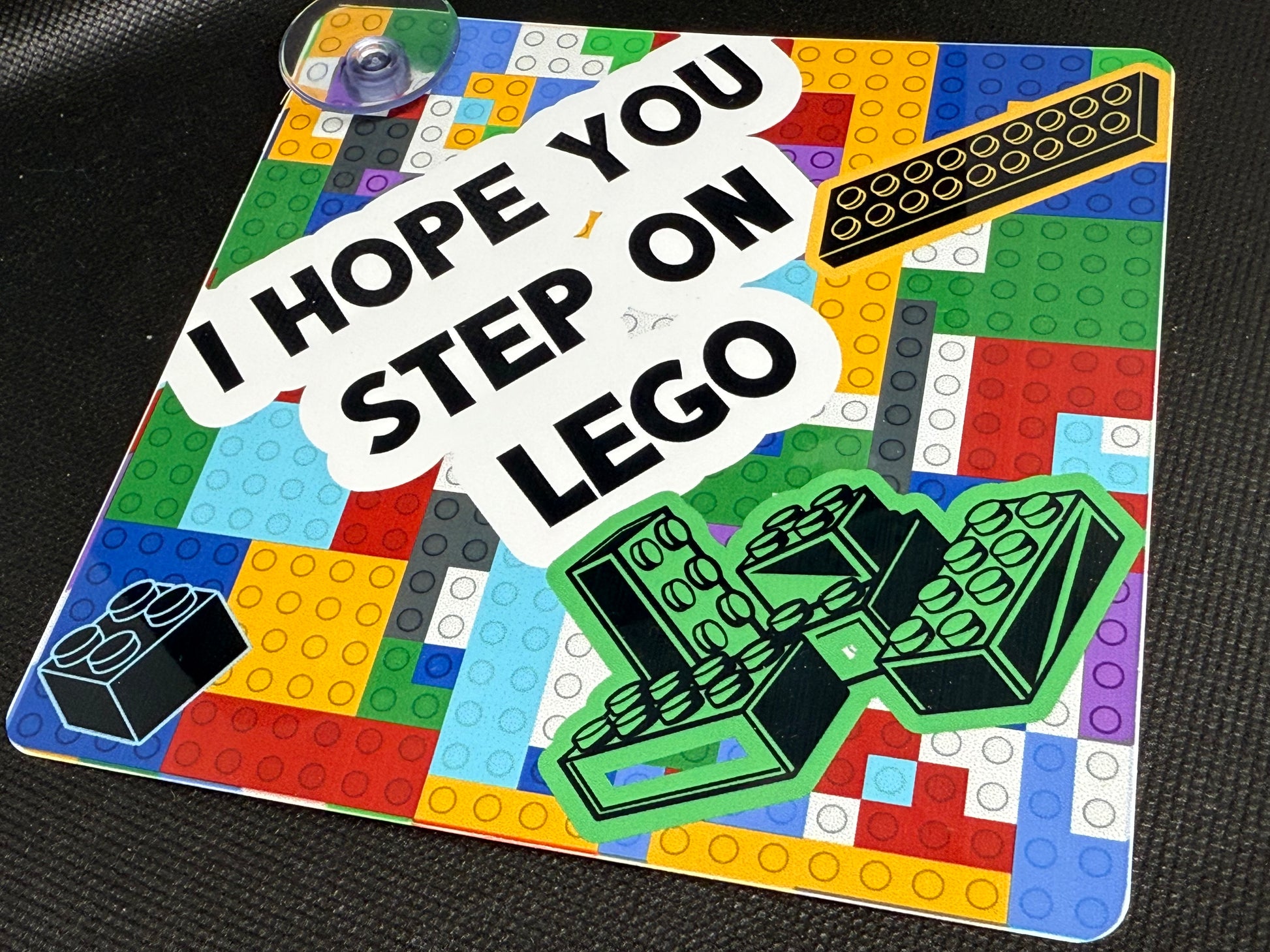 Colorful car sign with LEGO-themed design and text 'I hope you step on LEGO' 