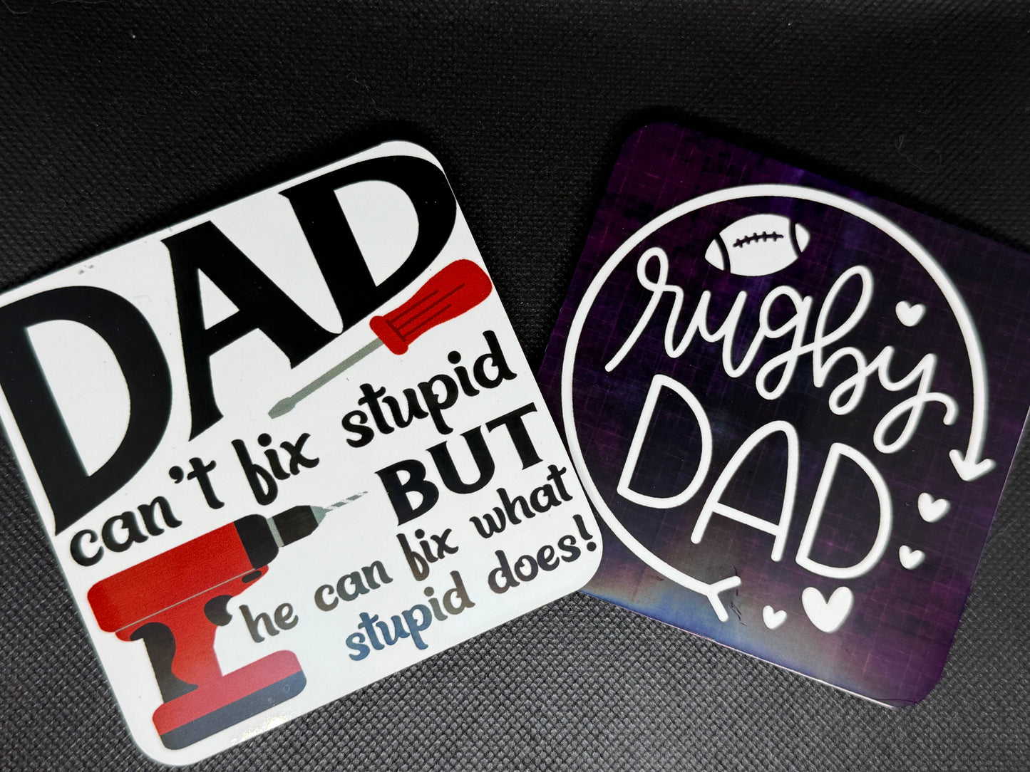 Two decorative coasters with humorous text and graphics 